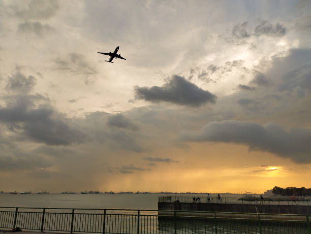 istock large aircraft landing behind a cloudy sky 2070910469