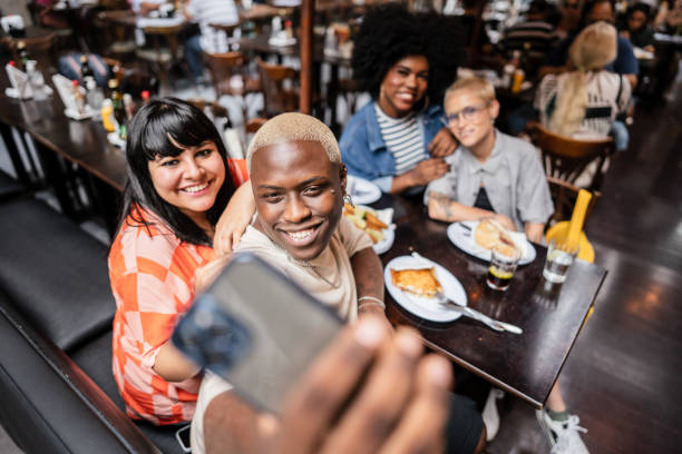 istock Group of friends taking a selfie at restaurant 2070914596