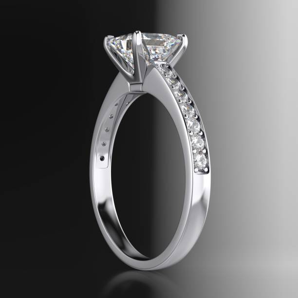 istock Diamond engagement ring with a radiant cut stone on black and white gradient background 2070926228