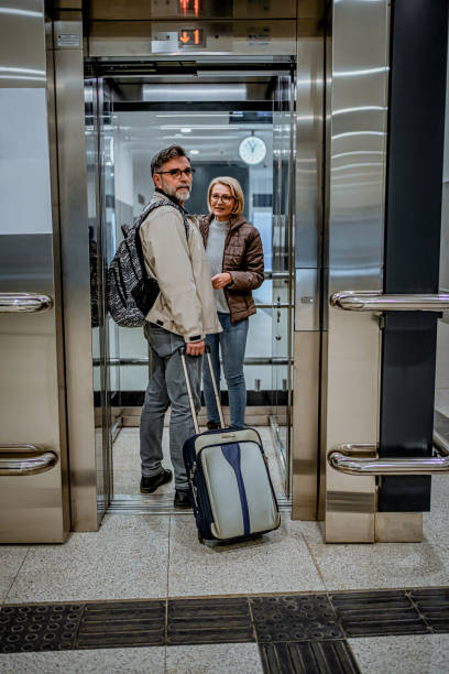 istock Mature couple of passengers entering the elevator 2070926347