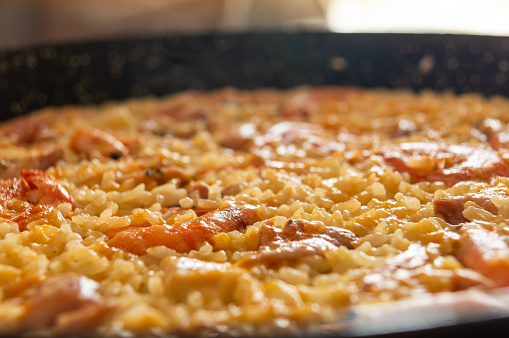 Mediterranean Delights: Paella with Seafood and Meat, Captured with Selective Focus.