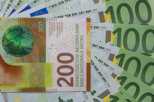 Closeup of 200 Swiss franc banknote and 100 euro banknotes for design purpose