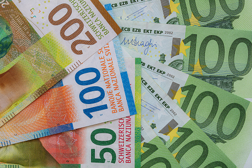 Closeup of 50, 100 and 200 Swiss franc banknotes and 100 euro banknotes for design purpose