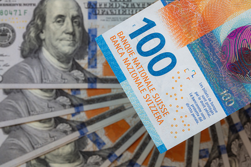 Closeup of 100  Swiss franc and 100 dollar banknotes for design purpose