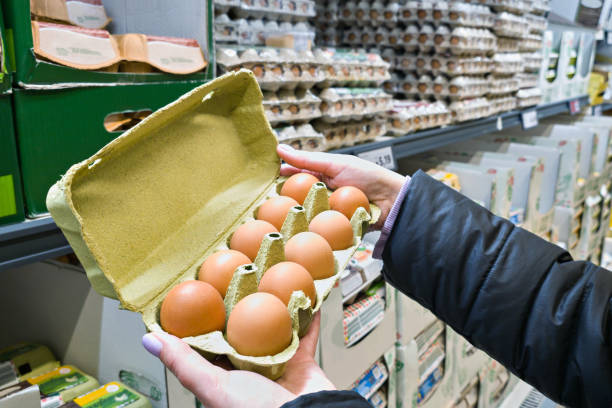 istock Hands with packages of eggs in store 2070930741