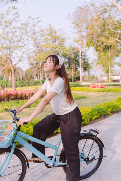 person with bike in nature park in vacation and mental wellbeing. - mental health women asian ethnicity bicycle 뉴스 사진 이미지