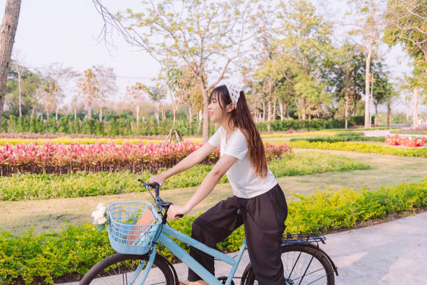 person with bike in nature park in vacation and mental wellbeing. - mental health women asian ethnicity bicycle zdjęcia i obrazy z banku zdjęć