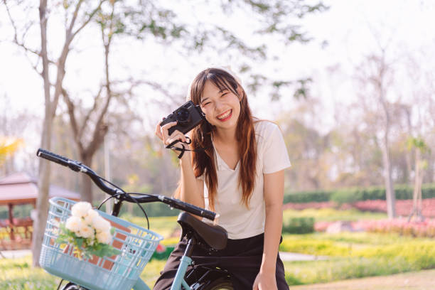 person with bike in nature park in vacation and mental wellbeing. - mental health women asian ethnicity bicycle zdjęcia i obrazy z banku zdjęć