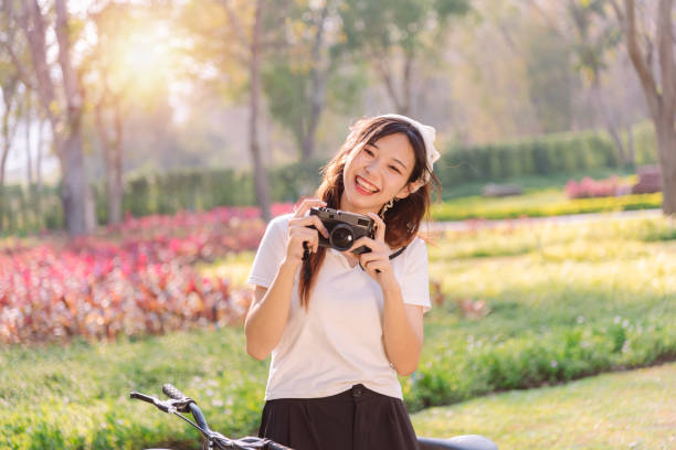 person with bike in nature park in vacation and mental wellbeing. - mental health women asian ethnicity bicycle zdjęcia i obrazy z banku zdjęć