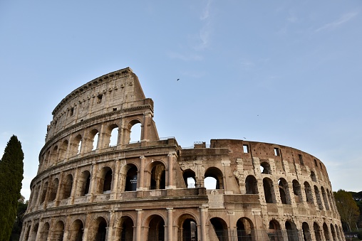 Detail the famous of the Coliseum or Flavian Amphitheatre (Colosseo), sunset sky scene at Rome, Italy.