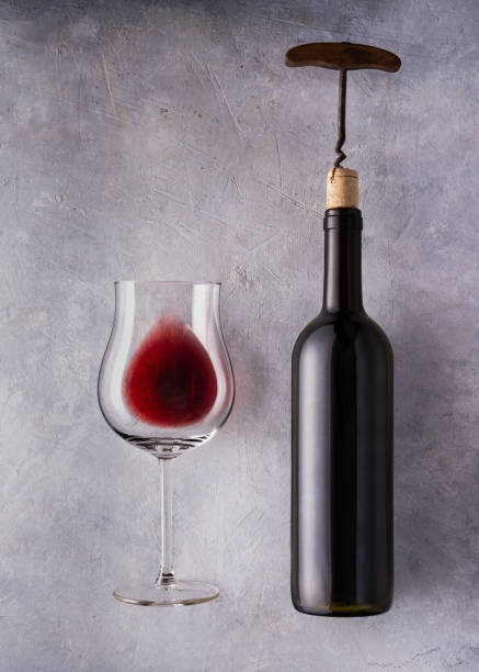 Red wine. Still life Still life. glass and bottle of wine to uncork. Textured background. crystal chalice stock pictures, royalty-free photos & images