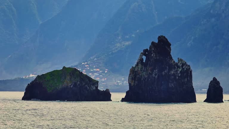 Aerial view big rock in the ocean at sunset, Miradouro da Ribeira da Janela. Madeira island, Portugal, Atlantic ocean.