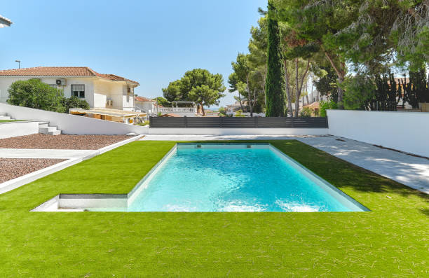 Green lawn with swimming pool view