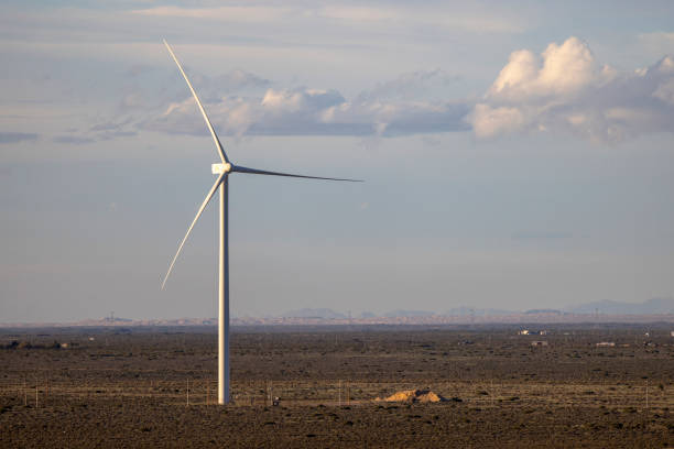istock Wind turbine on desert with lofty clouds in distance 2070964362
