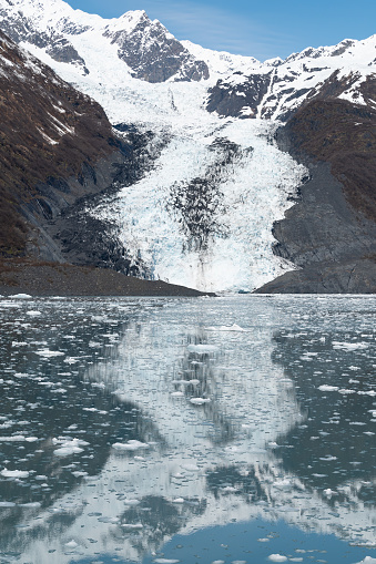 Tidewater Glacier reflected in the calm waters of College Fjord, Alaska, USA