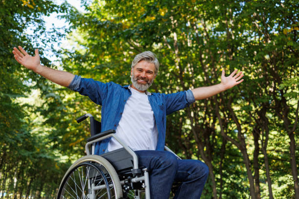 istock Park Pleasures: Man in Wheelchair Engaging with Open Arms 2070984920