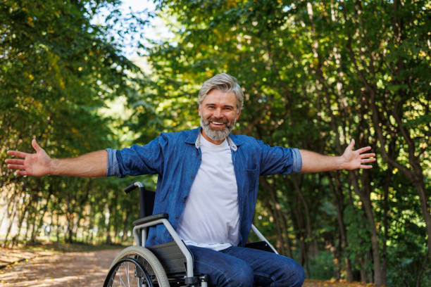 istock Reaching for Joy: Wheelchair-bound Man Embracing Nature 2070984921