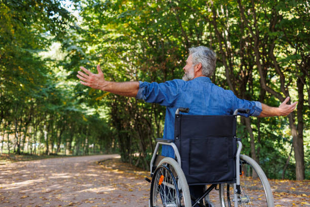 istock Touching Tranquility: Man in Wheelchair Connecting with Nature 2070985661