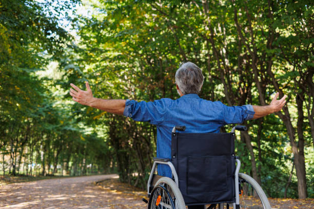 istock Expanding Horizons: Wheelchair User Reaching Out in Park 2070986027