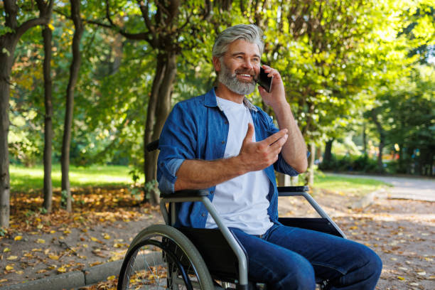 istock Accessibility in Action: Wheelchair User Engaged in a Call at the Park 2070986623
