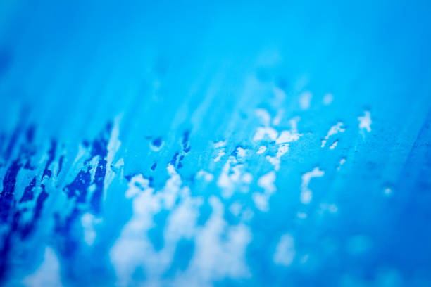 Extreme close up of blue acrylic paint texture showing brush strokes. Selective focus.