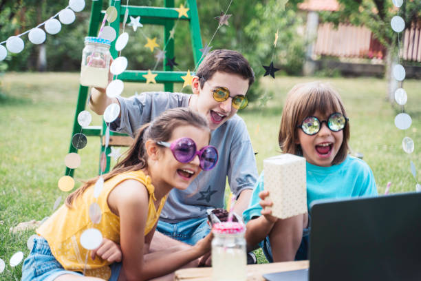 istock Happy children celebrating birthday online at backyard. 2070991559