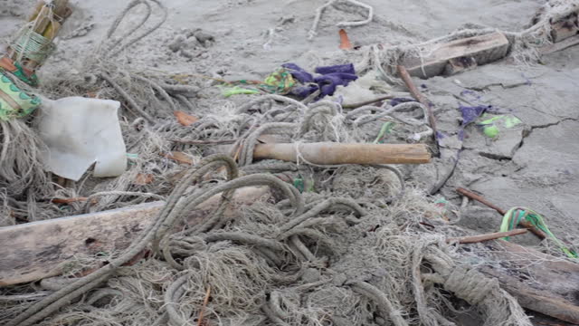 Discarded fishing nets. A section of broken and abandoned fishing nets lying on the beach of Sundarbans in Khulna district.