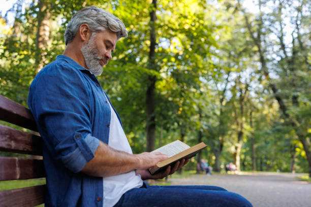 istock Literary Escape: Gentleman Reading in the Park 2071023619