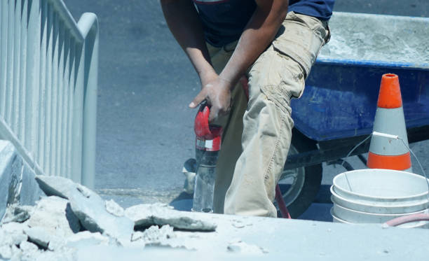 istock manual worker operating drill to repair the road 2071024693
