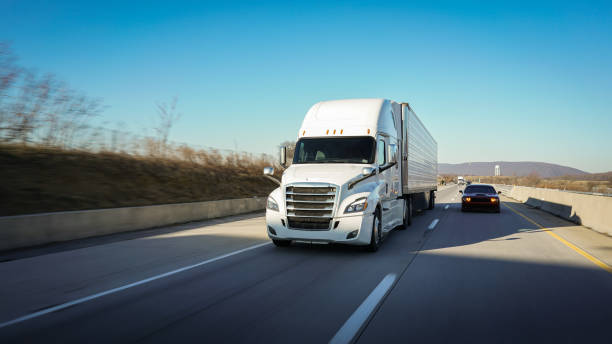 istock Big white 18 wheeler sleeper semi truck on the highway 2071045461