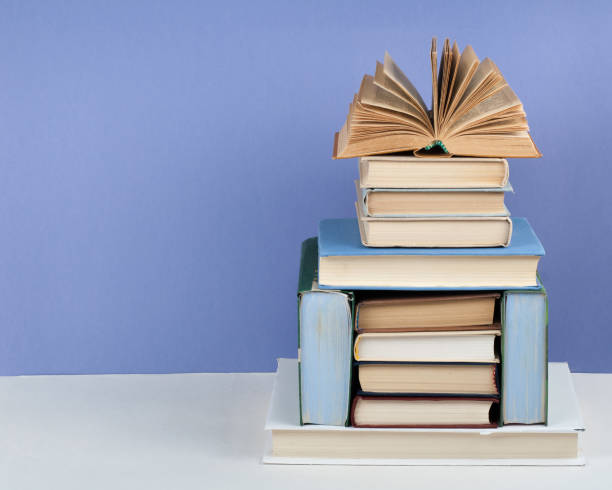istock Open book, hardback colorful books on wooden table. Back to school. Copy space for text. Education business concept. 2071059991