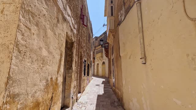 Walking Through Narrow Alley In Victoria On Gozo Island