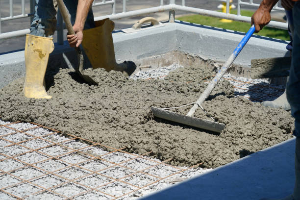 istock worker powering cement in the driveway construction site 2071067906