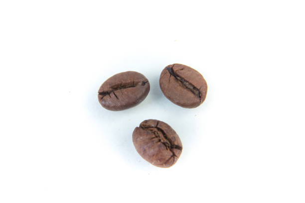 istock Several shiny freshly roasted coffee beans on a white background. 2071072123