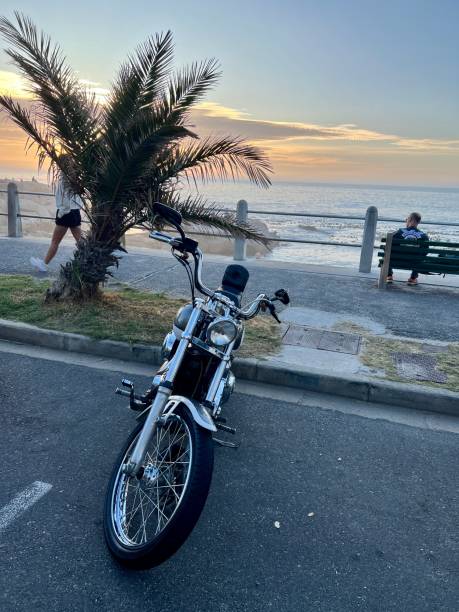 Cape Town, South Africa - November 16, 2023: Harley Davidson Motorcycle parked on Cape Town beach
