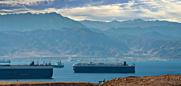Red Sea, straits and gulfs of the Red Sea, surrounding mountains, numerous cargo ships stranded due to Middle Eastern safety concerns in the region