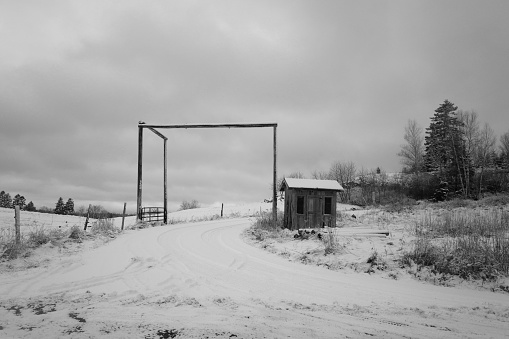 Snow-covered road and fenced-in area in winter