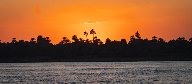 silhouette of the Nile river shoreline at sunset
