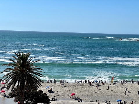 Cape Town, South Africa - November 26, 2023: Crowded beach in Camps Bay