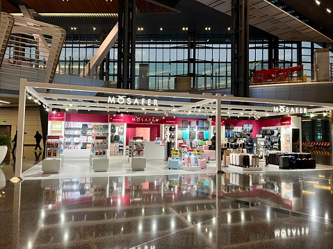 Doha, Qatar - November 28, 2023: Hamad International Airport terminal, inside view. Duty free shops and passengers walking through the airport