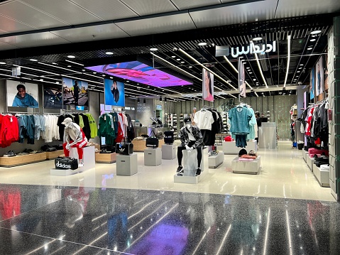 Doha, Qatar - November 28, 2023: Hamad International Airport terminal, inside view. Duty free shops and passengers walking through the airport
