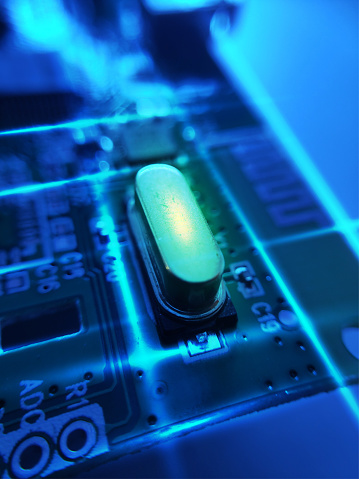 Image photograph of Electronic component. Close up image of crystal oscillator or electronic oscillator circuit.