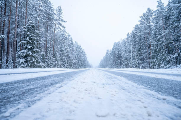 istock Winter road in the forest. Winter landscape with snow covered trees. 2071177047