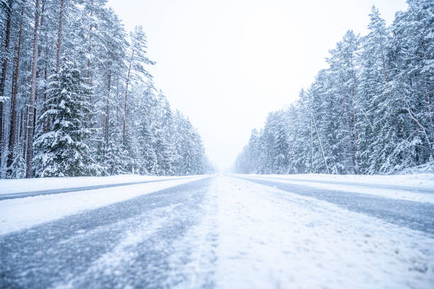 istock Winter road in the forest. Winter landscape with snow covered trees. 2071180754