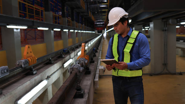 istock the electric train engineer inspects the  automatic track system control of the rails in the maintenance train station shop 2071245285
