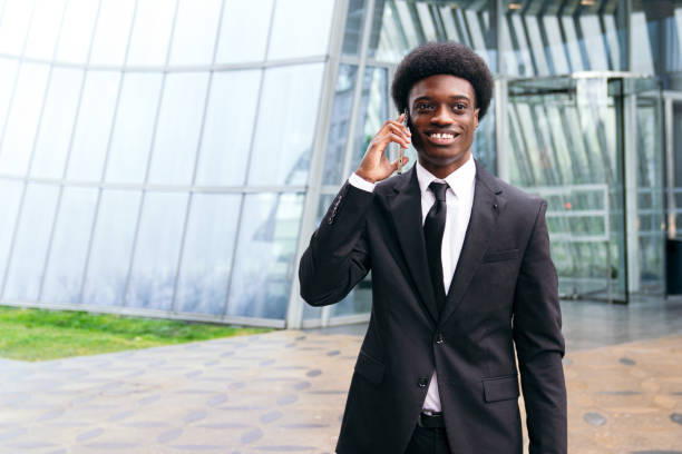 African businessman talking on the phone, modern backdrop.