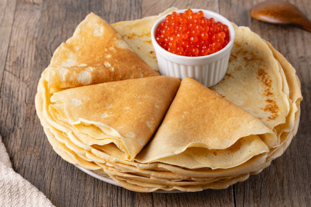 istock Pancakes with red caviar on a wooden table 2071256153