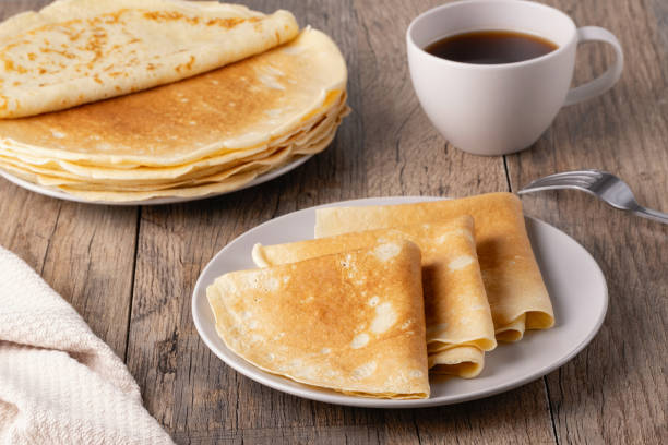 istock Stack of Russian thin pancakes and coffee on a wooden table 2071256659