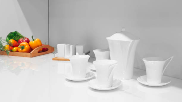 istock Set of clean plates, cups, teapot and saucers on white table 2071264457