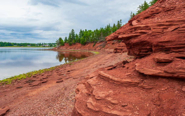 Swimming Rock - a public beach near red sandstone cliffs, on the north shore of Prince Edward Island, Canada. Swimming Rock - a public beach near red sandstone cliffs, on the north shore of Prince Edward Island, Canada. cavendish beach stock pictures, royalty-free photos & images